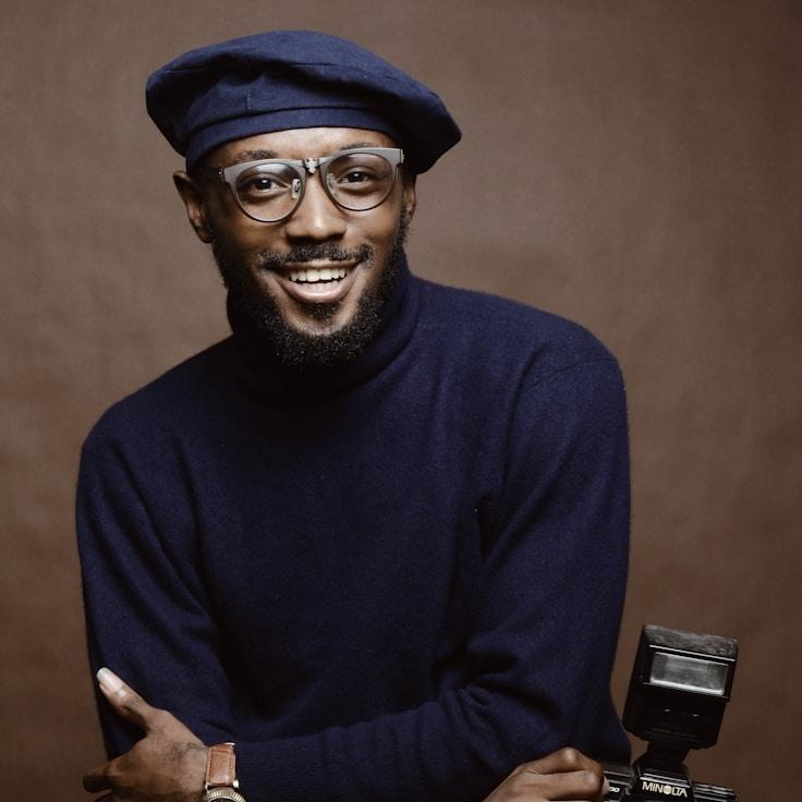 Avery Chen, Lead Design Curator at Open Clarity Space, reviewing corporate floral arrangements